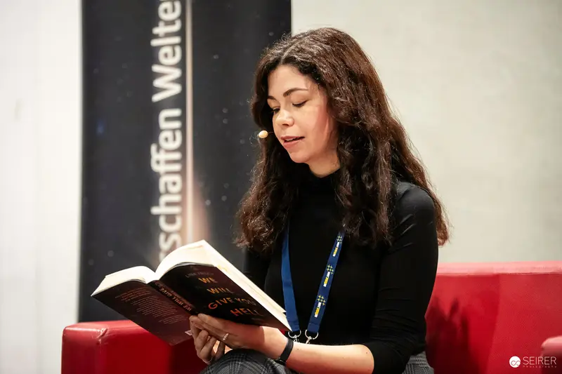 Intense Reading Moment at Literary Event with Woman in Black