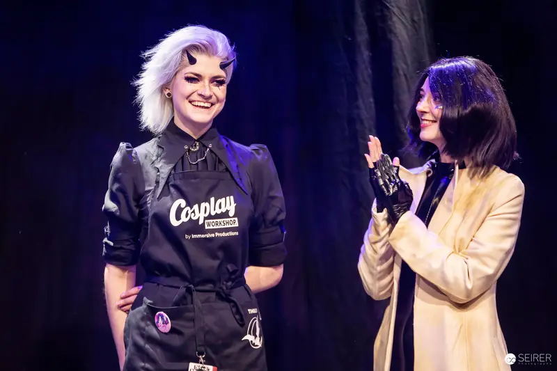 Cosplay Workshop staff member and applauding cosplayer on stage at Vienna Comic Con 2023