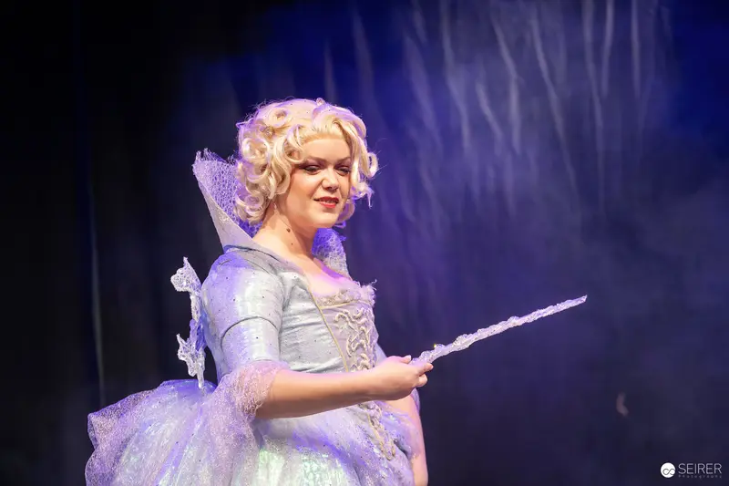 Fairy Godmother Cosplayer with Wand on Stage at VIECC Vienna Comic Con 2023