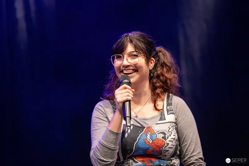Cosplay contest host in Spider-Man dress speaking on stage at VIECC Vienna Comic Con 2023
