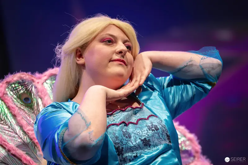 Cosplayer in Turquoise Satin Fairy Costume on Stage at VIECC Vienna Comic Con 2023