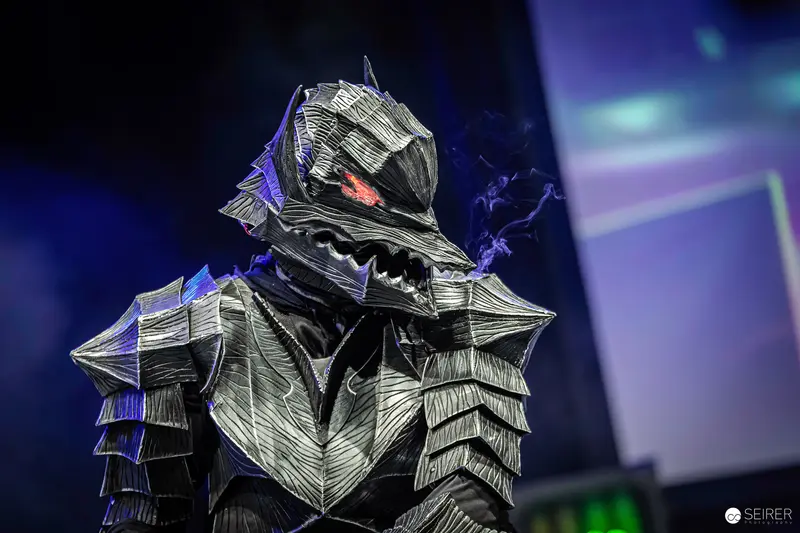 Armored Creature Cosplay with Glowing Red Eye on VIECC Vienna Comic Con Stage
