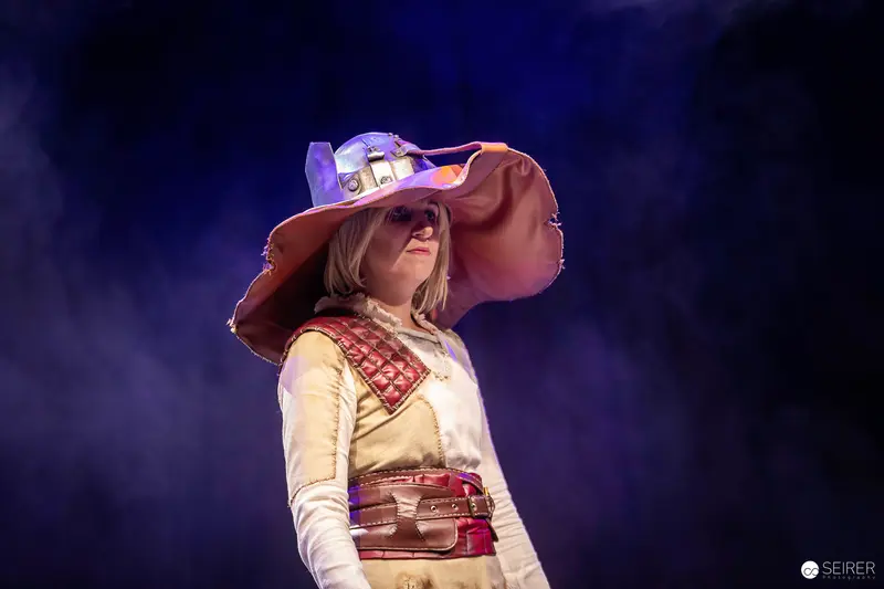 Cosplayer in wide-brimmed leather hat on stage at VIECC Vienna Comic Con 2023