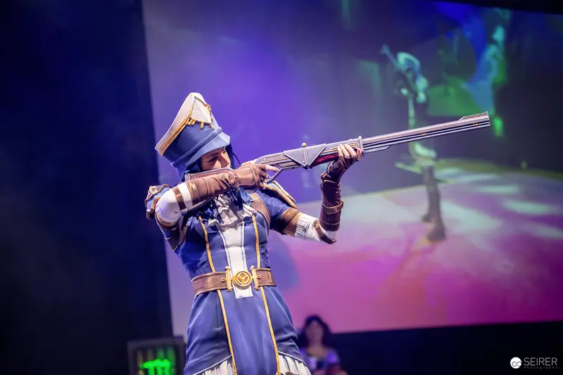 Caitlyn from League of Legends Cosplay Aiming Rifle on Stage at VIECC Vienna Comic Con 2023
