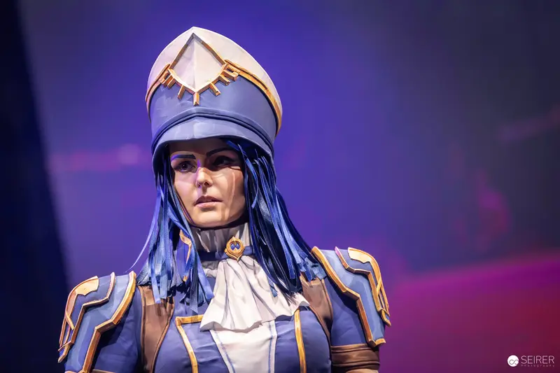 Cosplayer in Blue and Gold Armour with Peaked Helmet on VIECC Vienna Comic Con Stage