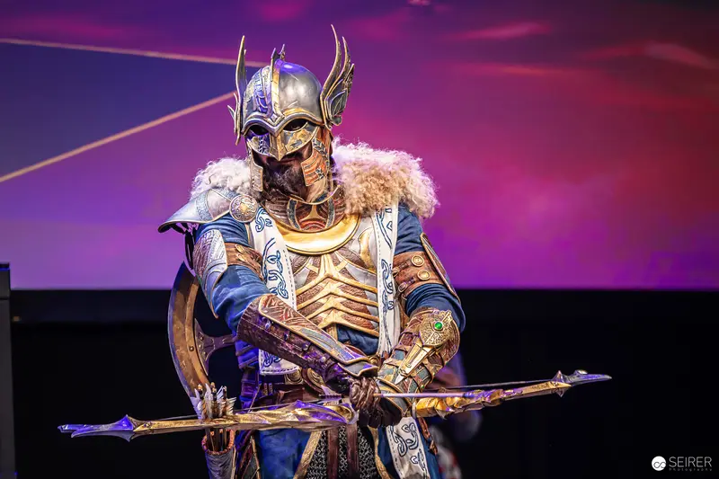 Winged-Helm Fantasy Warrior Cosplayer with Bow and Axe on VIECC Stage