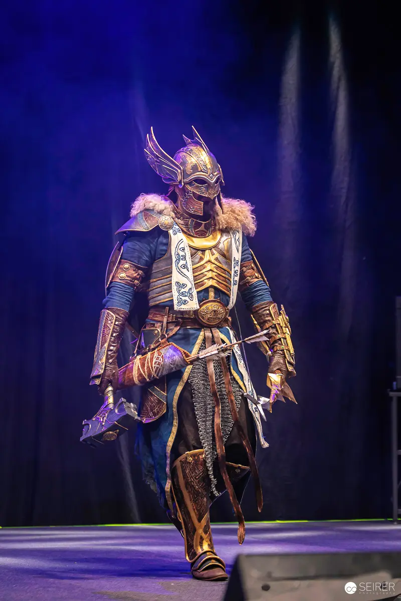Winged-Helmet Norse Warrior Cosplayer with Warhammer on Stage at VIECC Vienna Comic Con 2023
