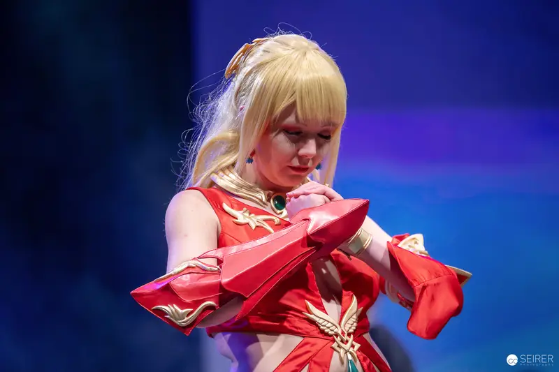 Cosplayer in red and gold armour on the VIECC Vienna Comic Con stage, November 2023