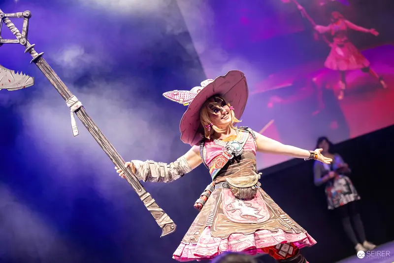 Cosplayer with Wide-Brimmed Hat and Staff on Stage at VIECC Vienna Comic Con 2023
