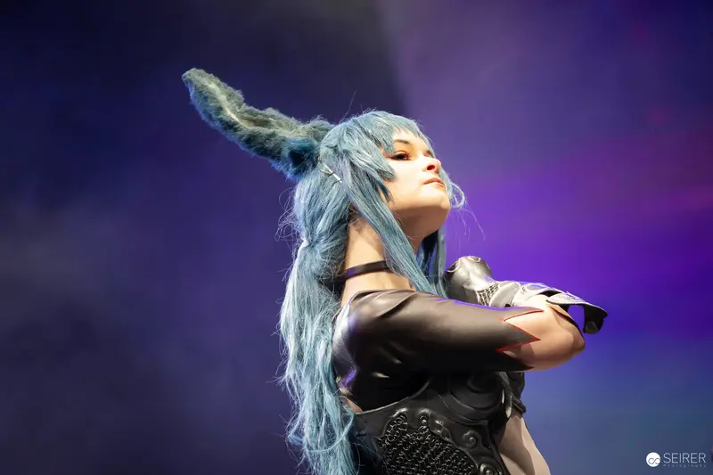 Blue-haired cosplayer with long animal ears on stage at VIECC Vienna Comic Con 2023