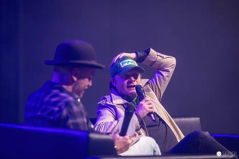 Panel guest in blue PING cap speaking on stage at VIECC Vienna Comic Con 2023