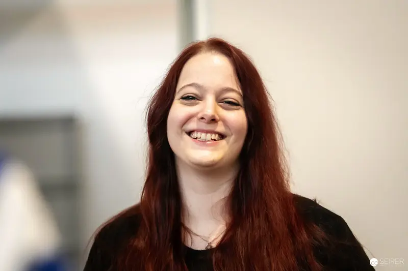 Smiling Attendee with Long Red Hair at VIECC Vienna Comic Con 2023
