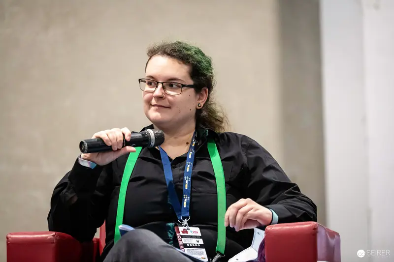 Panellist with Microphone and VIECC Contributor Lanyard at Vienna Comic Con 2023