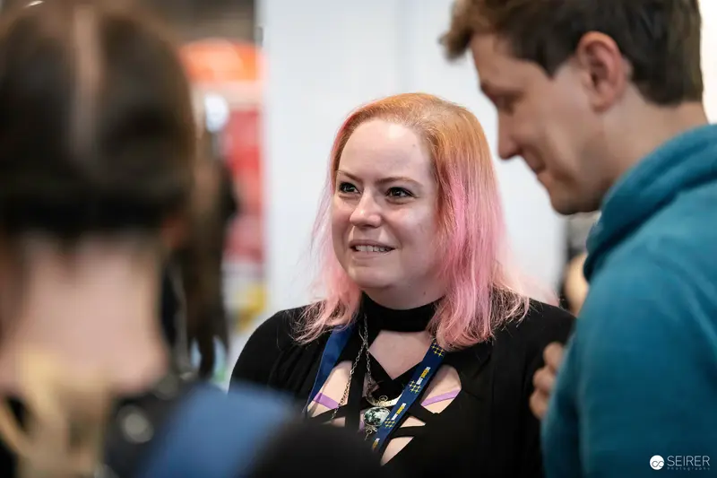 Attendee with Pink Hair and Exhibitor Lanyard at VIECC Vienna Comic Con 2023