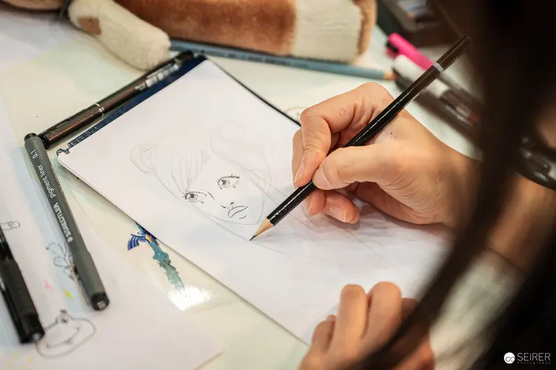 Artist Sketching Manga-Style Portrait in Pencil at Vienna Comic Con 2023