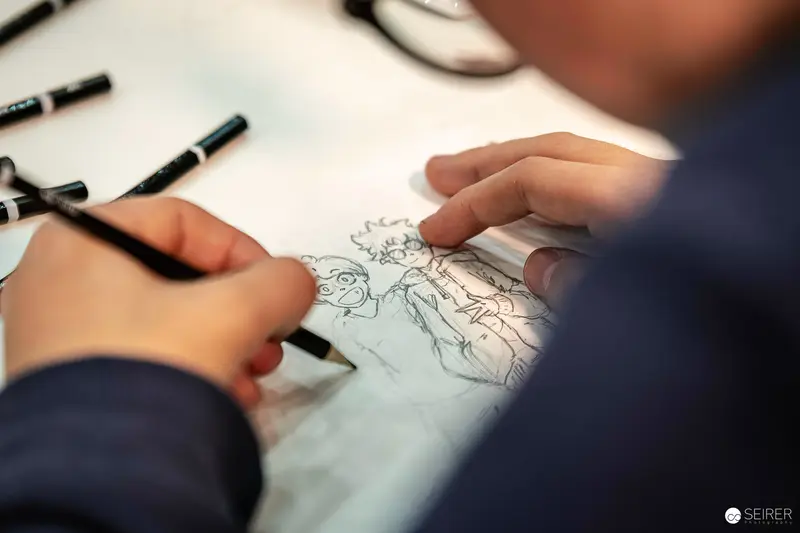 Artist Pencil-Sketching Two Manga Characters at VIECC Vienna Comic Con 2023