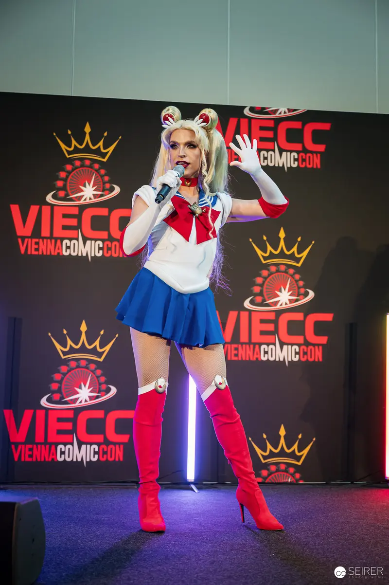 Sailor Moon cosplayer with microphone on VIECC Vienna Comic Con stage, November 2023