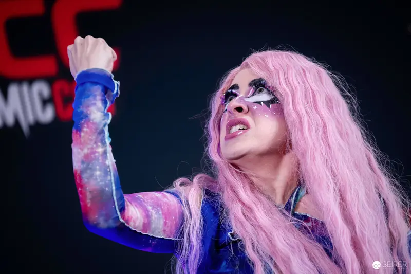 Cosplayer in Pink Wig and Galaxy Bodysuit on VIECC Vienna Comic Con Stage