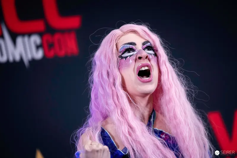 Cosplayer in Pink Wig and Graphic Eye Makeup on VIECC Vienna Comic Con Stage