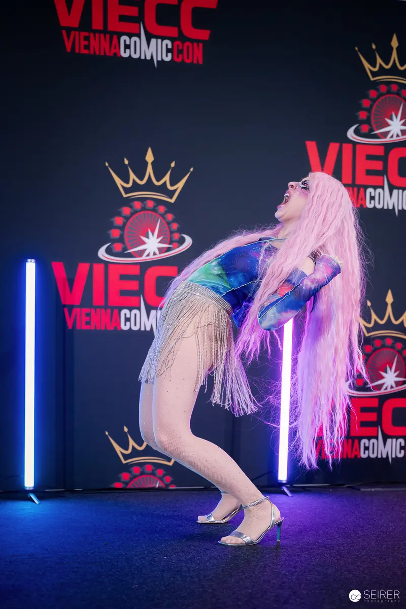 Cosplayer in Pink Wig and Fringed Bodysuit Performs on VIECC Vienna Comic Con Stage