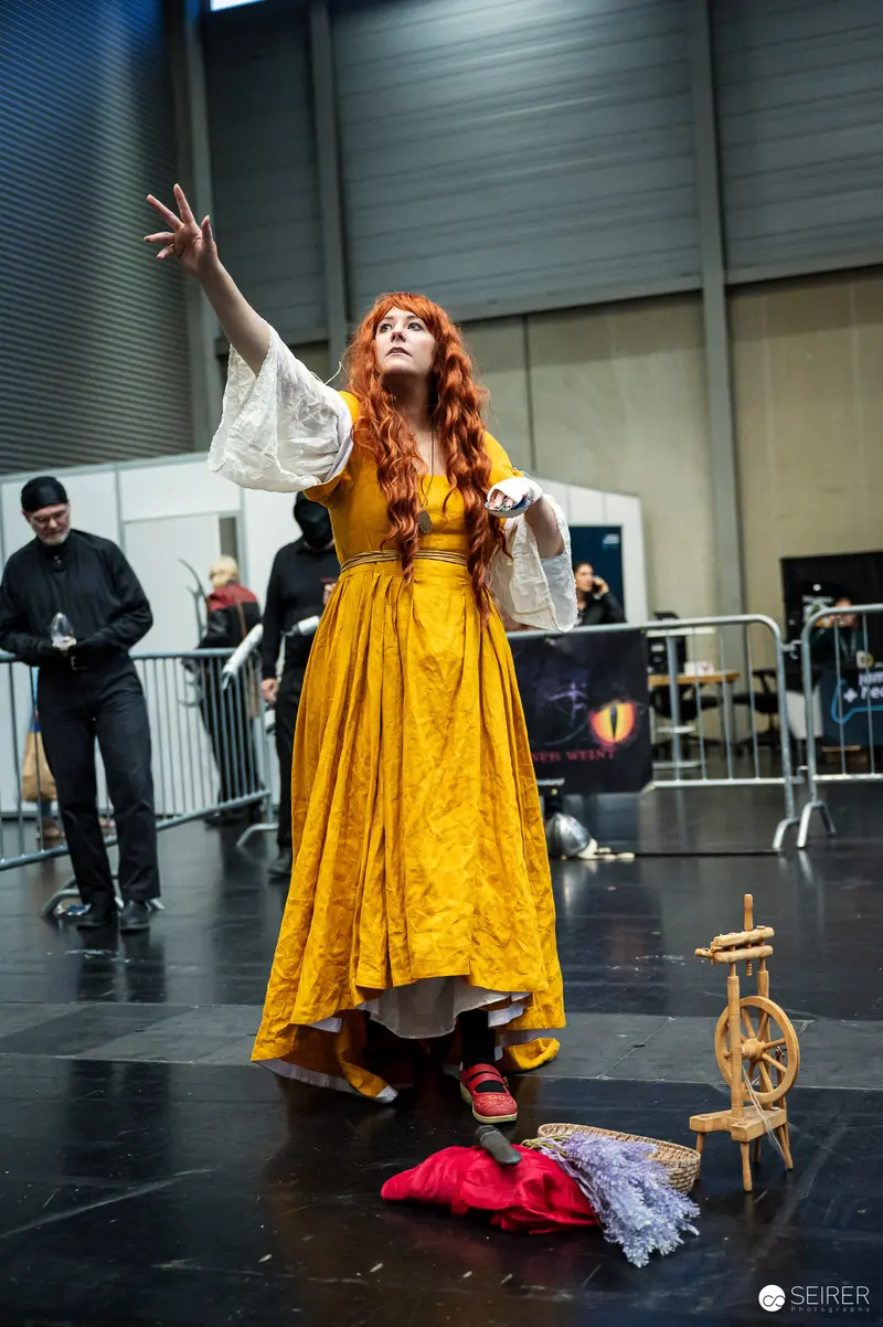 Cosplayer in Yellow Gown with Spinning Wheel at VIECC Vienna Comic Con 2023