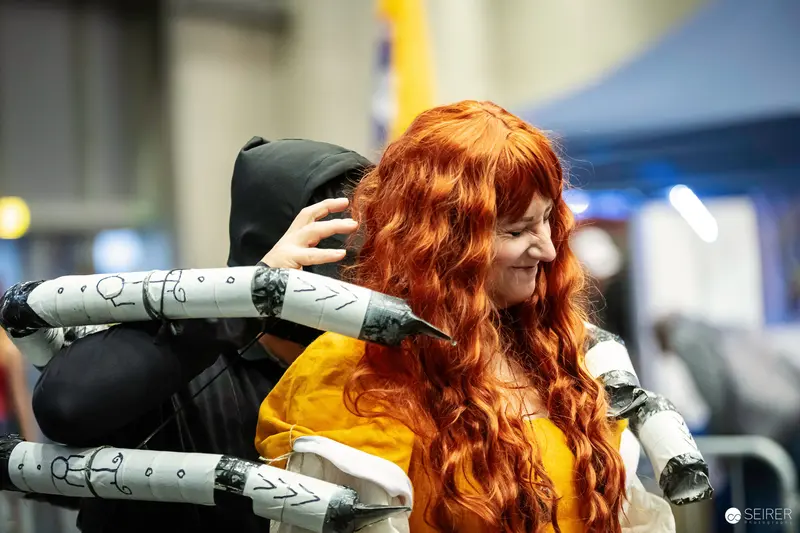 Cosplayer in Long Red Wig and Clawed Gauntlets at VIECC Vienna Comic Con 2023