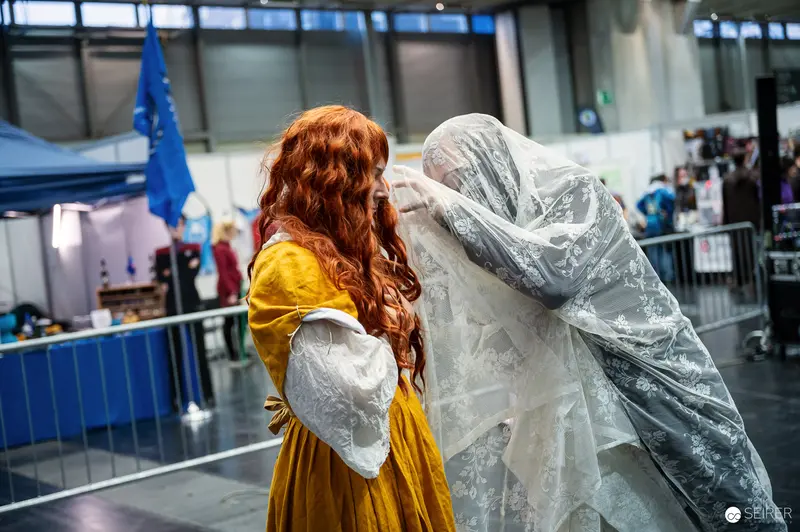 Cosplayers in Yellow Gown and Grey Ghost Veil at Vienna Comic Con 2023
