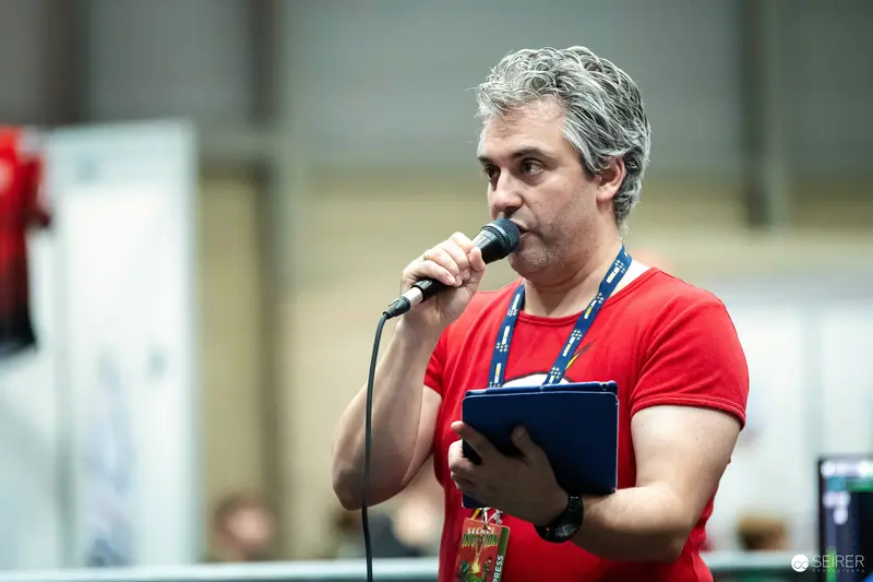 Host with Handheld Microphone and Clipboard at VIECC Vienna Comic Con 2023