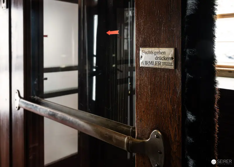 Historic "Rechts gehen drücken" enamel sign on Südbahnhotel door, Semmering