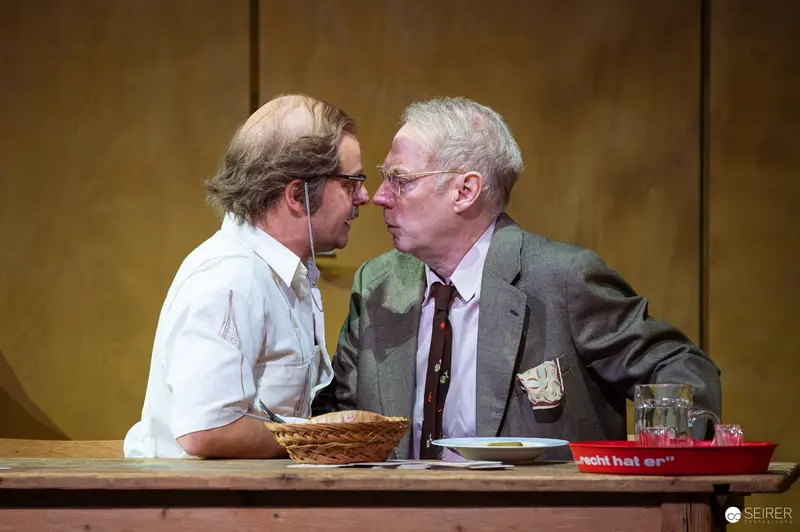 Intense Dialogue Between Two Men at Theatrical Performance