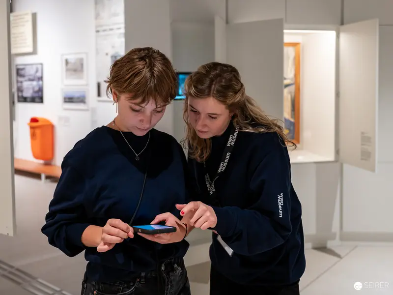 Two Students Exploring Digital Content at Wien Museum Preopen Renovation