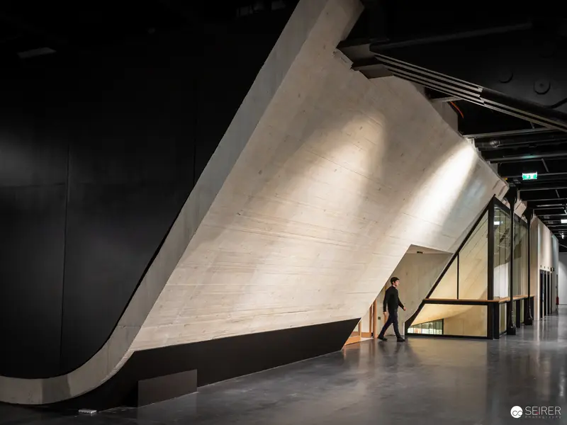 Wien Museum Renovation Reveals Dramatic Curved Concrete Wall and Architectural Space