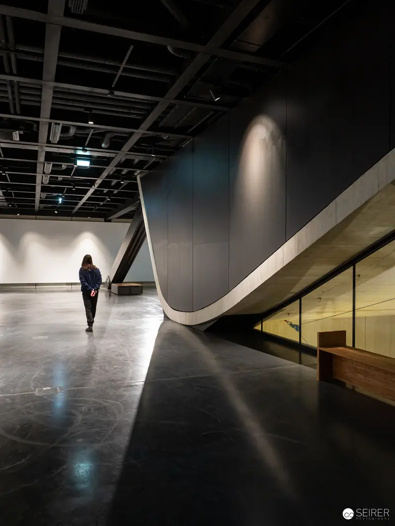 Lone Visitor Explores Renovated Wien Museum's Minimalist Interior