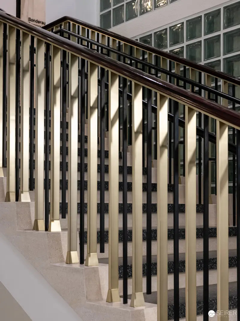 Elegant Modern Staircase with Black and Gold Architectural Balusters