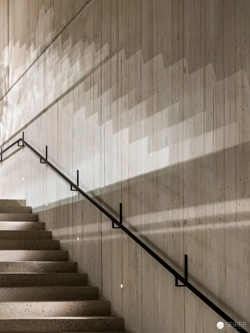Minimalist Concrete Staircase with Geometric Shadows at Wien Museum Renovation