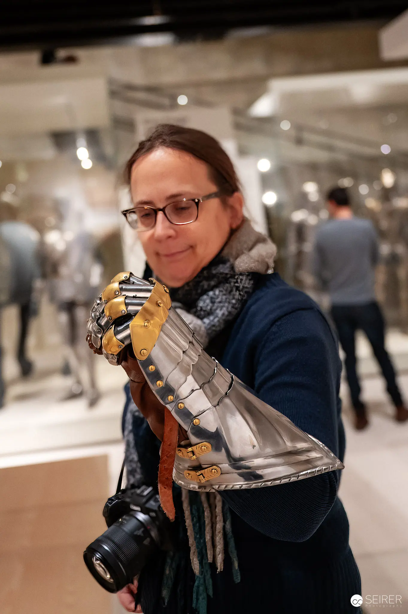 Curator Exploring Medieval Armor Exhibit at Wien Museum Photography Display