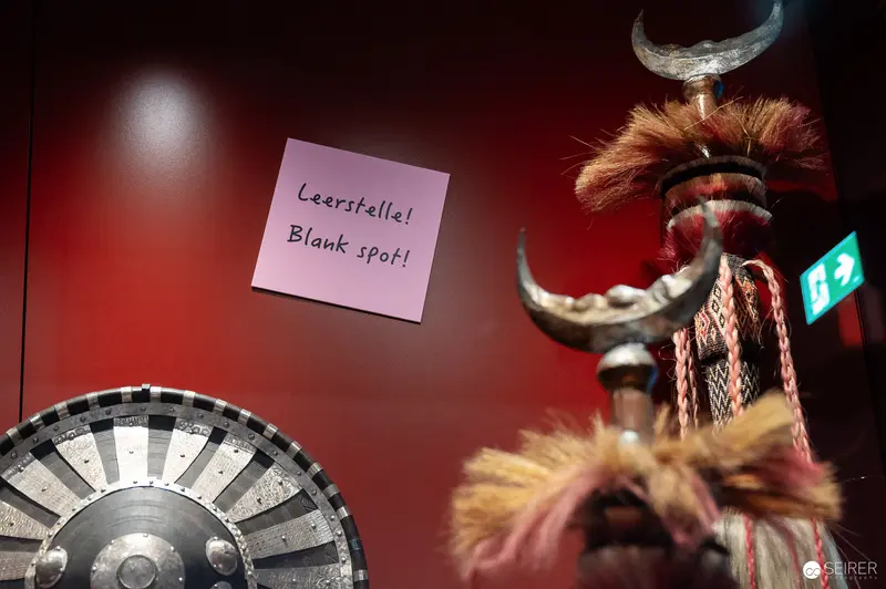 Leerstellel Blank Spot: Museum Exhibit with Wheel and Tribal Artifact