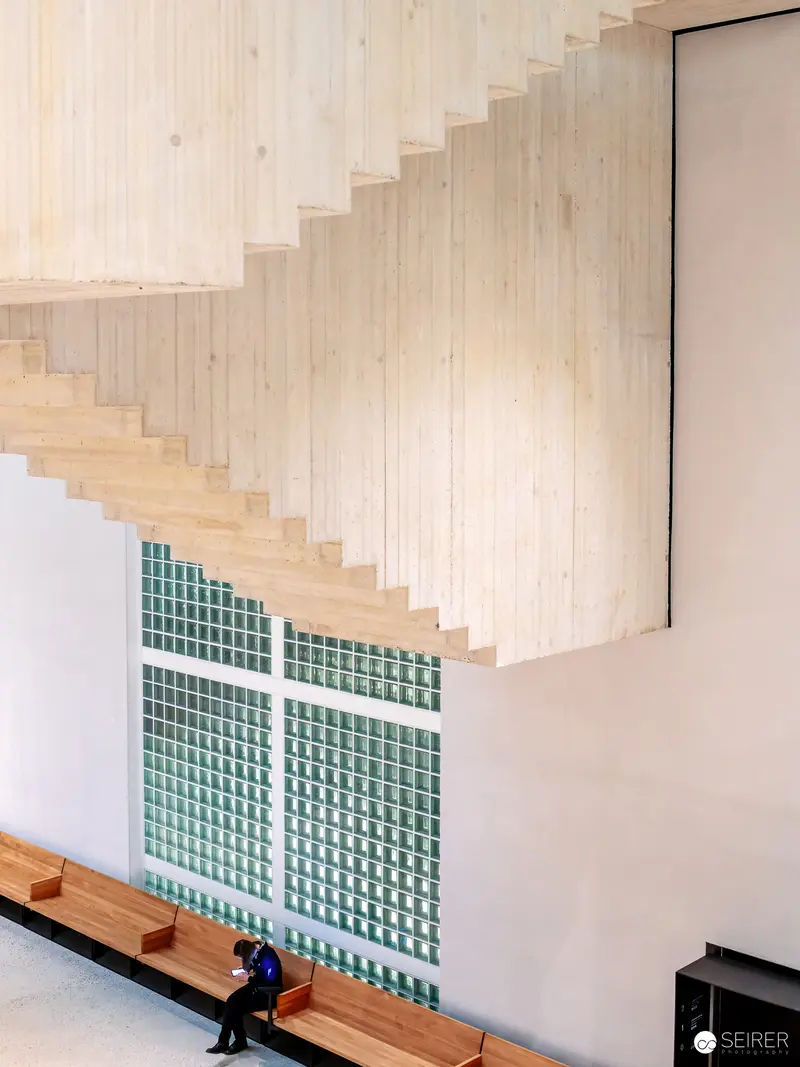 Minimalist Staircase Interior with Seated Figure at Wien Museum