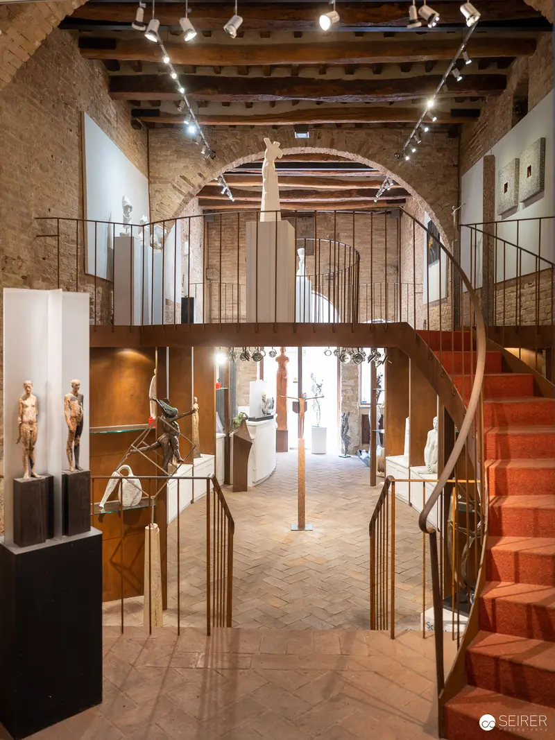 Contemporary Sculpture Display in Restored Stone Gallery with Architectural Layering