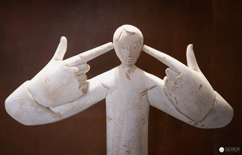 Ceramic Sculpture of Hands Pointing at Distressed Figurine