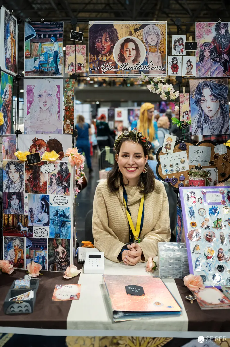 Artist Showcasing Artwork at Vienna ComicCon 2023 Illustration Exhibition Booth