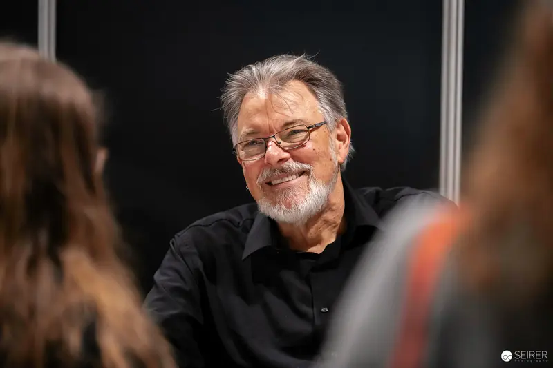 Smiling Attendee in Black at Vienna ComicCon 2023