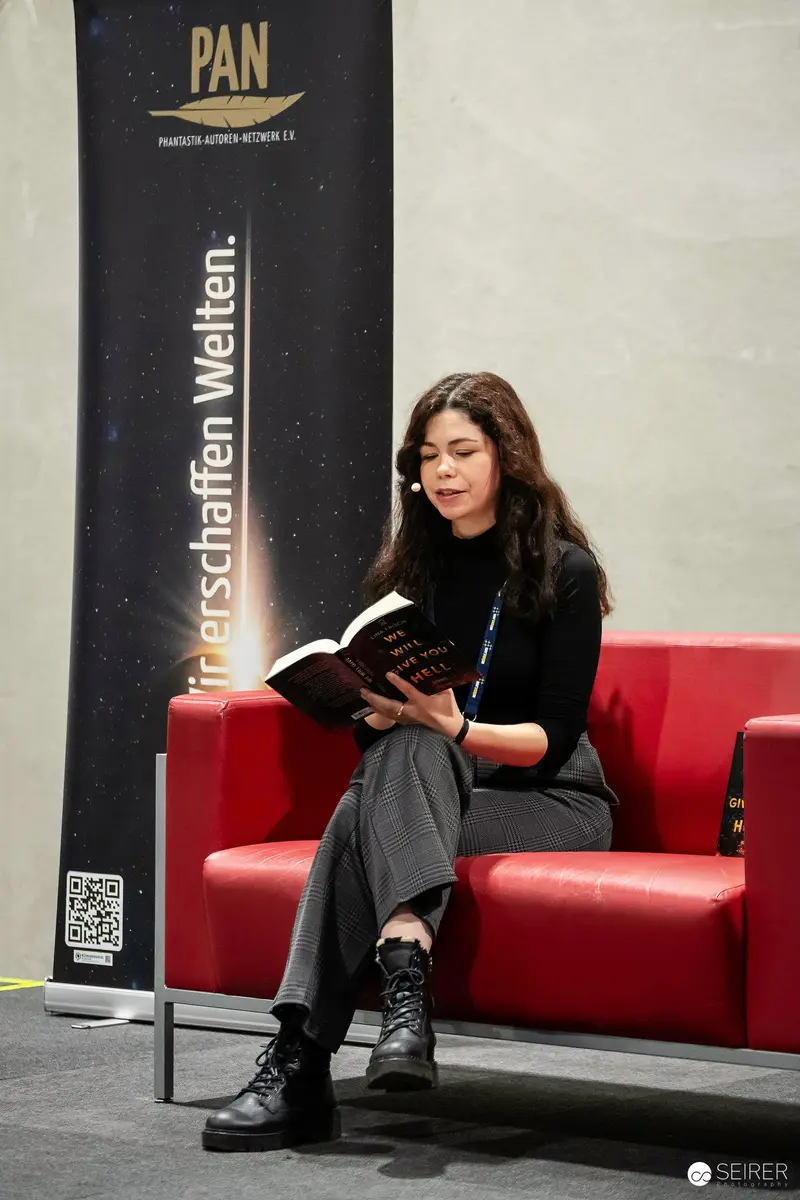 Woman Reading Book at PAN Publishing Event in Vienna