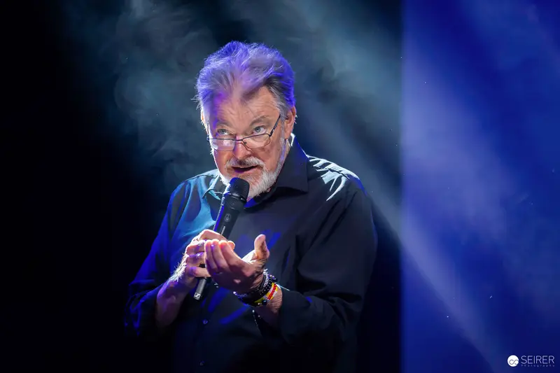 Comedian Performing with Microphone at Vienna ComicCon 2023