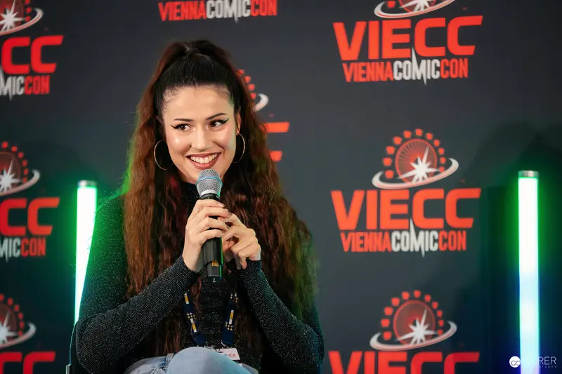 Woman Speaking at Vienna Comic Con 2023 Panel Discussion