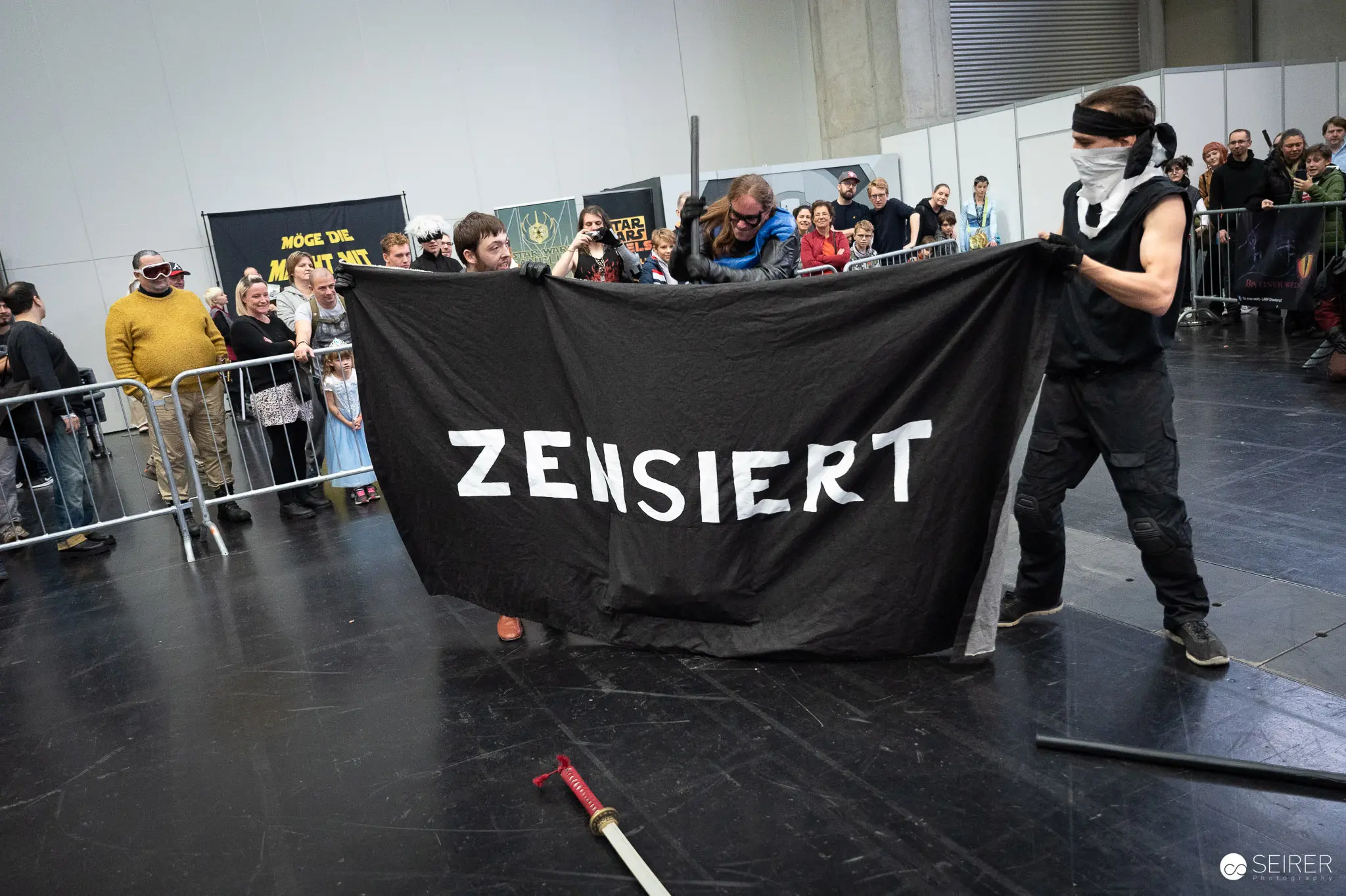 Protest Against Censorship at Vienna ComicCon 2023 with Black "ZENSIERT" Banner