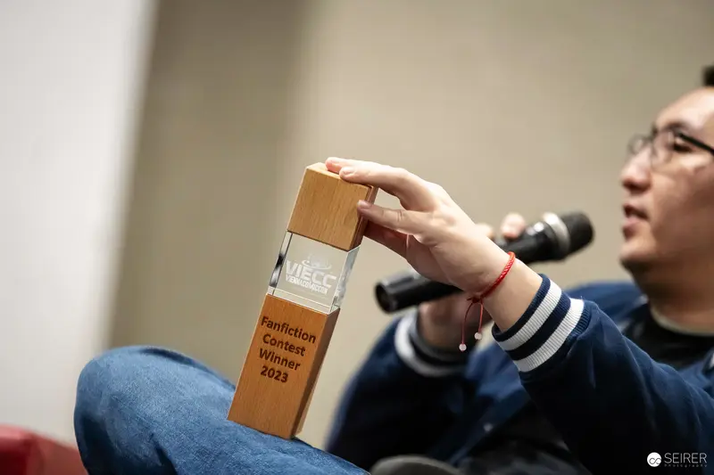 Vienna ComicCon 2023: Award Winner Holding Wooden Trophy at Event