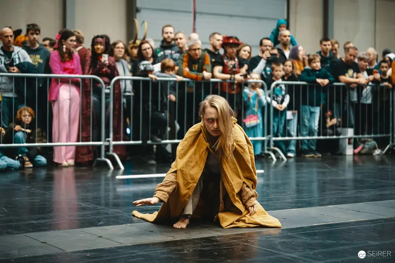 Performer in Yellow Coat at Vienna ComicCon 2023 Lightsaber Battleshow