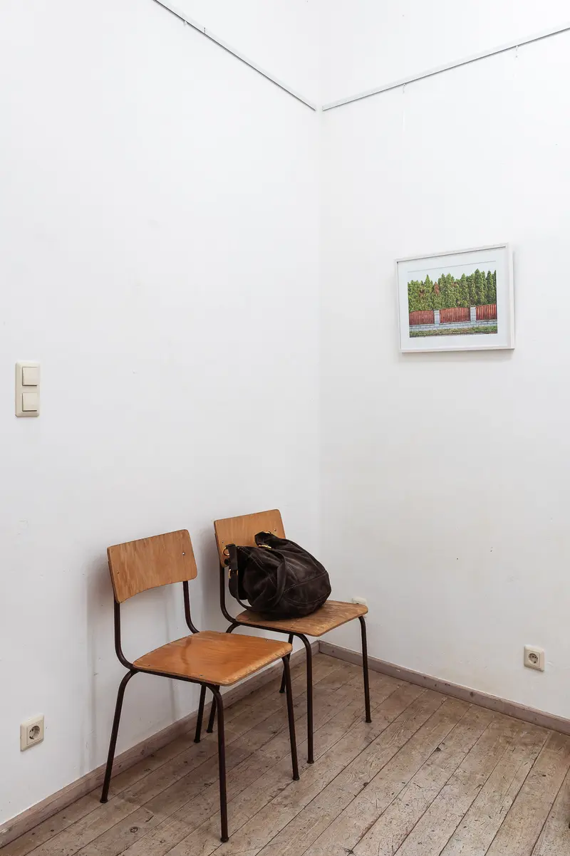 Minimal Interior with Wooden Chairs and Black Bag in White Room