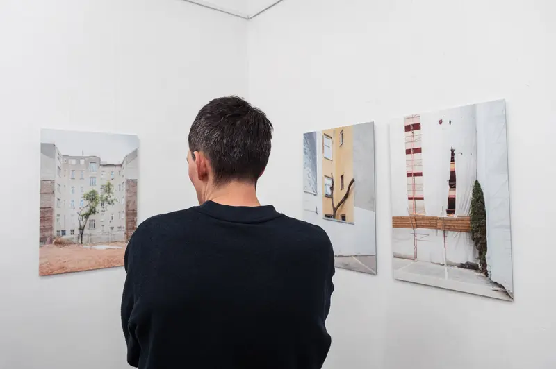 Viewer Observes Urban Photography Exhibit at Diploma Exhibition